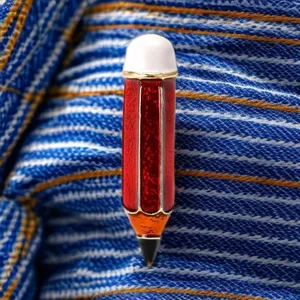 Primer plano detalle de un broche de lápiz de esmalte de aleación creativa para ropa.