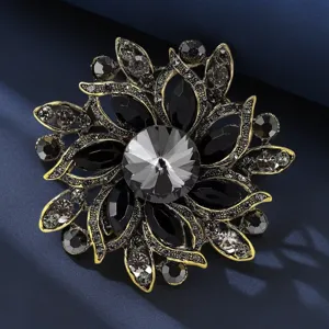 Close-up detail of vintage crystal flower brooch, intricate metal framework and sparkling stones.