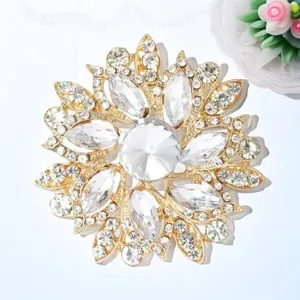 Close-up of a stunning gold crystal rhinestone flower brooch, sparkling detailed jewelry design.