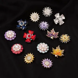 Detailopname van diverse sprankelende strass bloemen en bladeren drukknopen voor kraag.