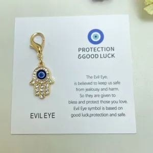 Pendentif breloque œil maléfique main de Hamsa dorée avec strass pour porte-clés et sac.