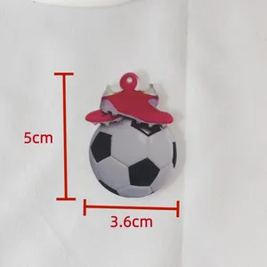 Close-up detail shot of the acrylic football and soccer cleats keychain charm, clear display.