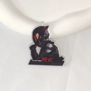 Detailed shot of a cartoon motorcycle acrylic keychain charm with RK engine graphic design.