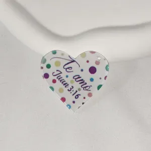 Heart shape acrylic DIY keychain pendant with colorful dots and text print, detailed view.