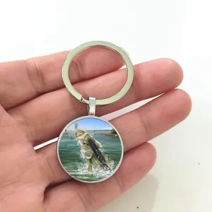 Detailed view of a fishing enthusiast time gemstone keychain featuring a realistic bass fish.