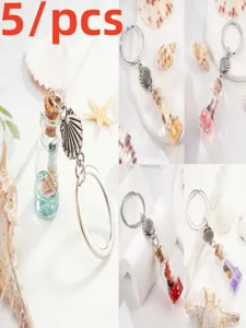 Ocean wishing bottle keychain with shell charm and mini glass bottle for gifts and travel.