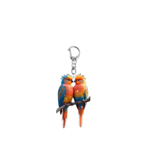 Close-up of double-sided printed acrylic parrot keychain featuring colorful bird design.