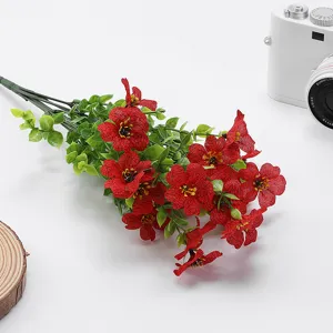 Artificial red flower bouquet with green leaves for home decoration and vase display.