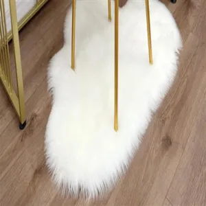 White fluffy plush irregular cloud rug detail view, soft cozy home decor floor mat for living room.