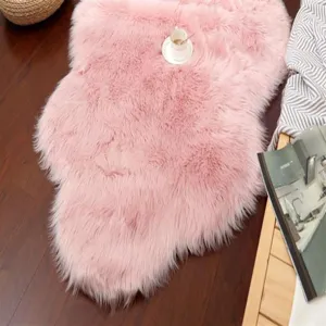 Pink fluffy faux fur rug detail shot, soft plush texture for cozy bedroom and living room decor.