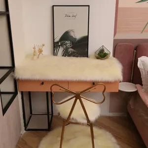 Faux sheepskin furry desk mat detail view, soft plush table protector and chair pad setup.