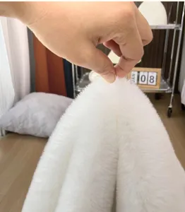 White plush rug detail showing soft fluffy texture and high thickness for cozy bedroom floor mat.