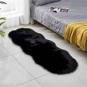 Black faux fur sheepskin rug, soft fluffy bedside carpet and cozy bedroom floor mat decor.