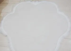 White cat paw shaped plush rug soft fluffy bedroom floor mat detail close up view
