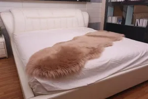 Faux wool plush runner rug detail, soft pinkish brown bedroom decor, fluffy bedside mat.