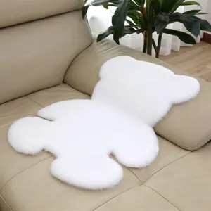 Detail shot of the cute white bear plush rug, soft fluffy texture for bedroom floor decor.