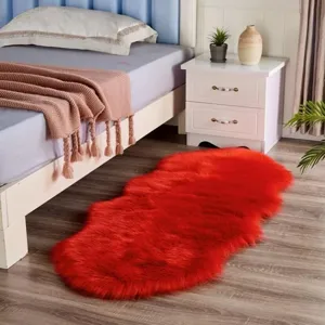 Detailed view of the red faux sheepskin rug, fluffy plush floor mat for bedroom or living room.