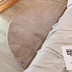 Soft faux rabbit fur semi-circular floor mat detail, cozy bedroom bedside rug texture.