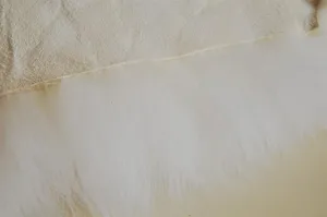 Pure wool sofa cushion detail image, soft natural sheepskin texture for home comfort.