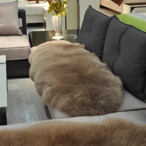 Close-up of soft fluffy brown sheepskin rug texture, cozy home decor detail for your sofa.