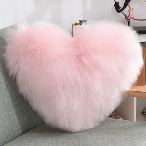 Pink heart-shaped plush throw pillow, fluffy faux fur cushion for sofa, bed, and office chair.