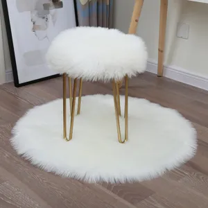 White fluffy faux fur round rug and furry stool set for bedroom and living room decor.