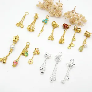 Assorted gold and silver charms featuring flowers, gourds, and pearls for DIY jewelry making.