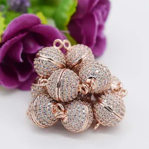 Close-up of sparkling cubic zirconia magnetic ball clasp in rose gold finish for DIY jewelry.