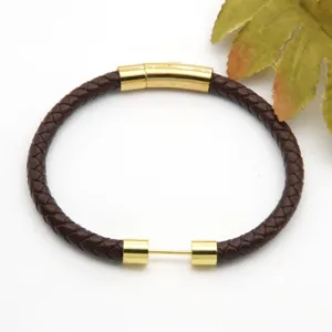 Detailed view of braided brown leather bracelet featuring golden stainless steel magnetic clasp.