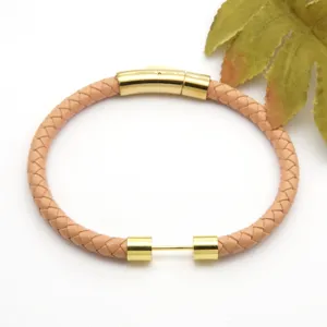 Braided leather bracelet with gold stainless steel clasp detail showing fine texture and design.