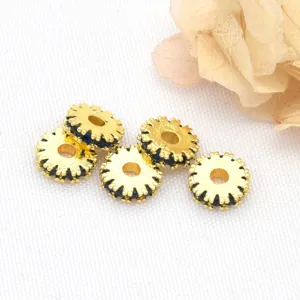 Close-up of gold gear spacer beads with blue rhinestone inlay for DIY bracelet making