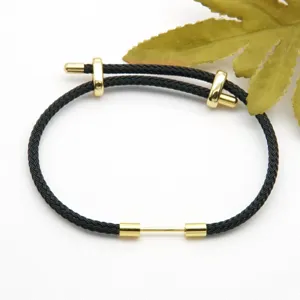 Black braided cord adjustable bracelet with gold metal details, versatile minimalist jewelry piece.
