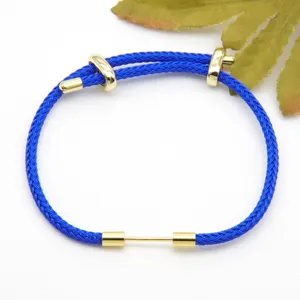 Blue woven cord bracelet detail with gold metal components, stylish DIY accessory for couples.