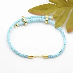 Light blue braided rope bracelet with gold metal accessories, versatile DIY jewelry piece.