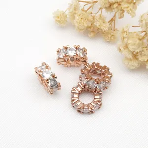 Close-up detail of rose gold rhinestone spacer beads, perfect for DIY jewelry making bracelets.