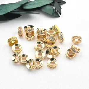 Gold plated micro pave zirconia spacer beads for DIY jewelry making, detailed shot of round charms.