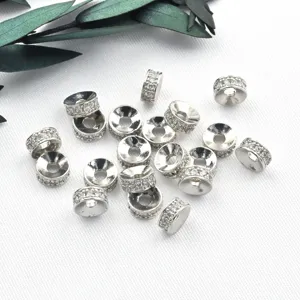 Close-up detail of silver micro pave cubic zirconia round spacer beads for DIY jewelry crafts.