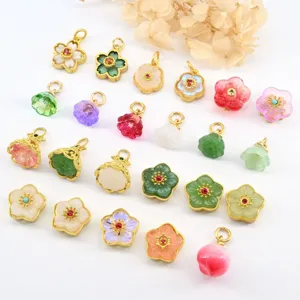 Assorted gold-plated gemstone flower and peach jewelry charms, perfect for DIY bracelets.
