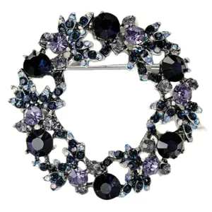 Elegante spilla a corona di strass con cristalli blu scuro e viola per giacca da donna.