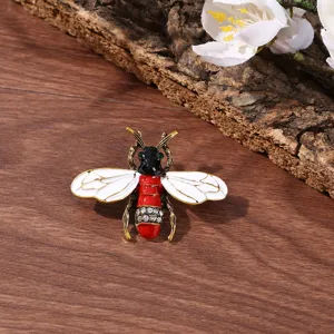 Close-up detail of vintage insect brooch, exquisite rhinestone and enamel design on metallic base.