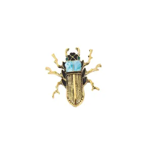 Vintage gold-tone beetle insect brooch pin featuring chic black enamel and blue stone accents.