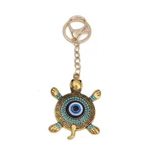 Evil eye turtle keychain with blue rhinestones, stylish metallic bag pendant and keyring charm.