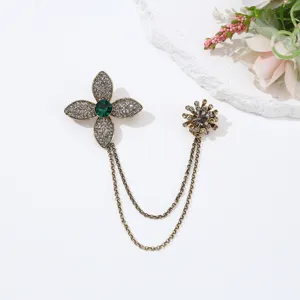 Vintage crystal rhinestone flower brooch detail, elegant double chain fashion accessory.