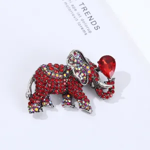 Detailed closeup of the luxury rhinestone elephant brooch featuring vibrant red crystal details.
