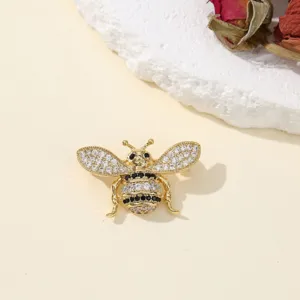 Exquisite bee insect brooch detail, sparkling crystal rhinestone lapel pin accessory.