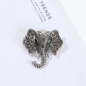 Detailed close-up of the vintage silver elephant brooch, featuring sparkling rhinestones.