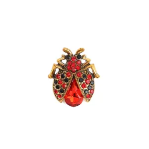 Detailed view of the vintage ladybug brooch featuring sparkling red and black rhinestones.