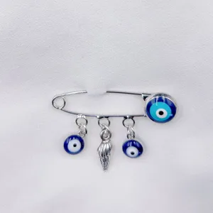 Silver safety pin brooch featuring blue evil eye glass beads and shell pendant for daily wear.