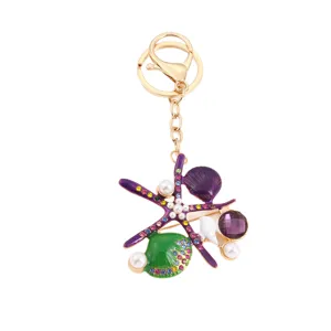 Mooie oceaan zeester en schelp sleutelhanger tasbedel met kleurrijke strass steentjes.