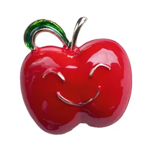 Cute red apple brooch pin with smiling face, creative enamel fruit corsage for women outfit.